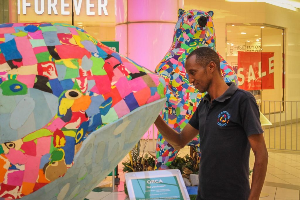 Ocean Sole Africa artist Jonathan with Orca Whale