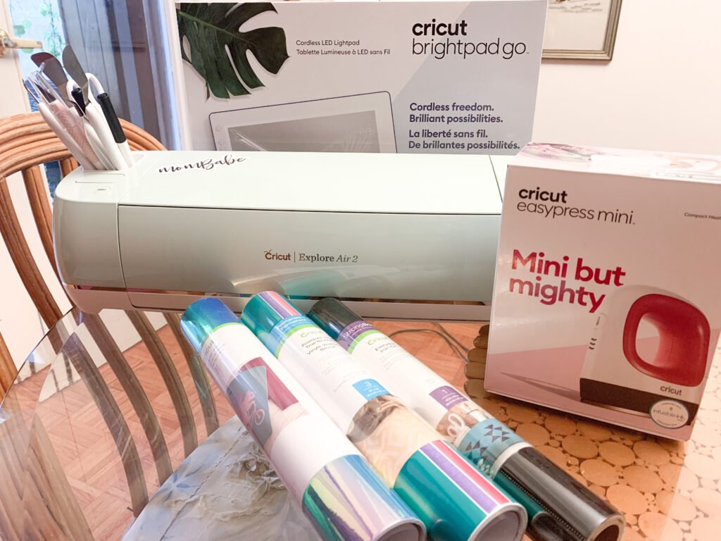 Cricut Explore Air 2 machine beside Cricut Easy press Mini and Brightpad Go