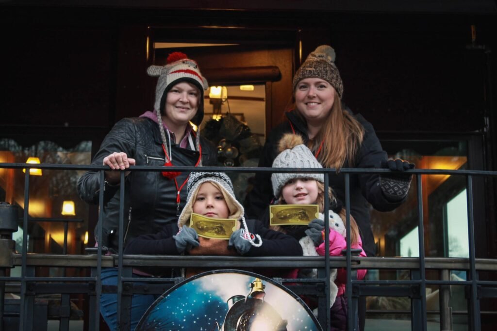 Tara & Helisa with kids standing on the Polar Express