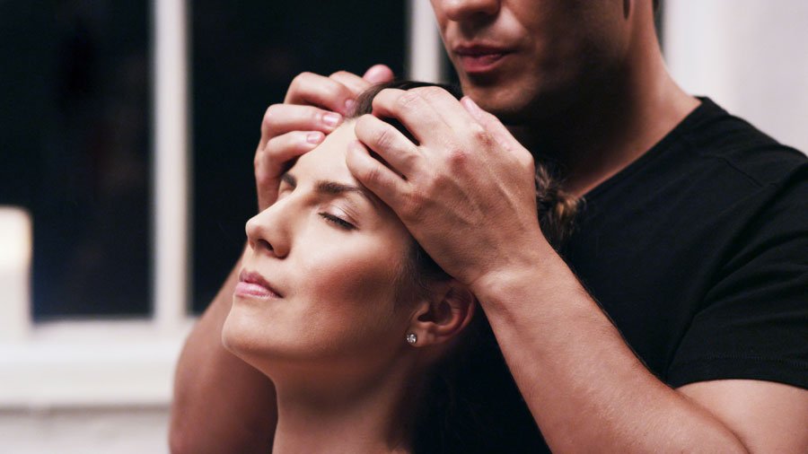 Denis Merkas from Melt Massage for Couples giving a head massage