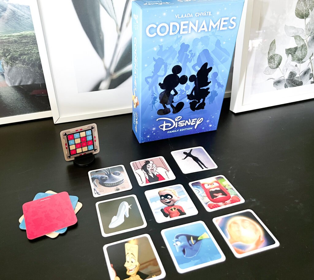 Disney Codenames cards on a black surface 