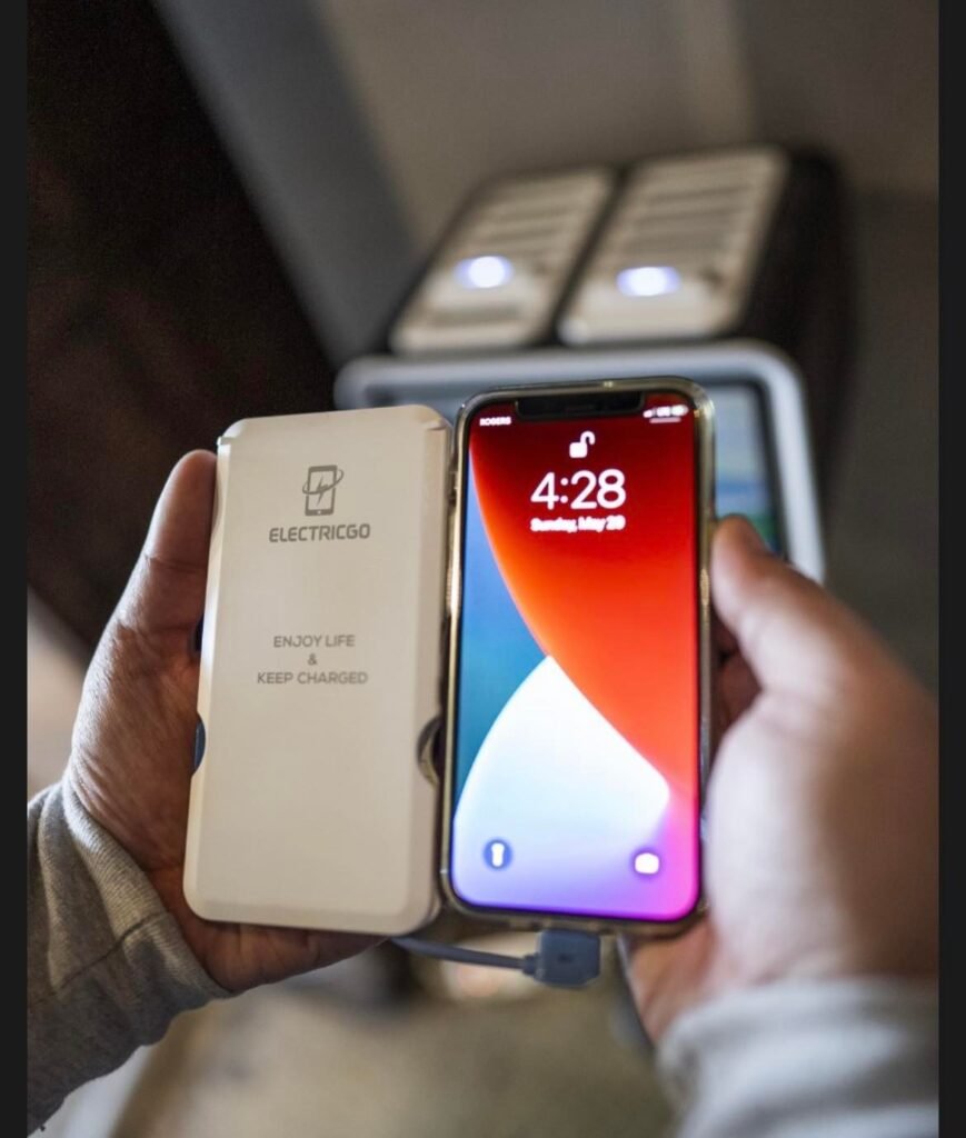 Photo of a cell phone next to an ElectricGo charging bank