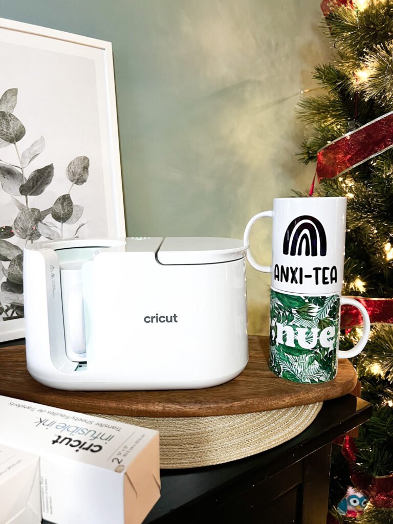 Mugs stacked next to Cricut Mug Press